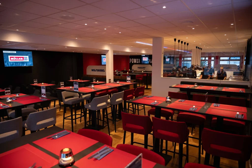 Blick durch den VIP-Bereich mit Hochtischen und Theke